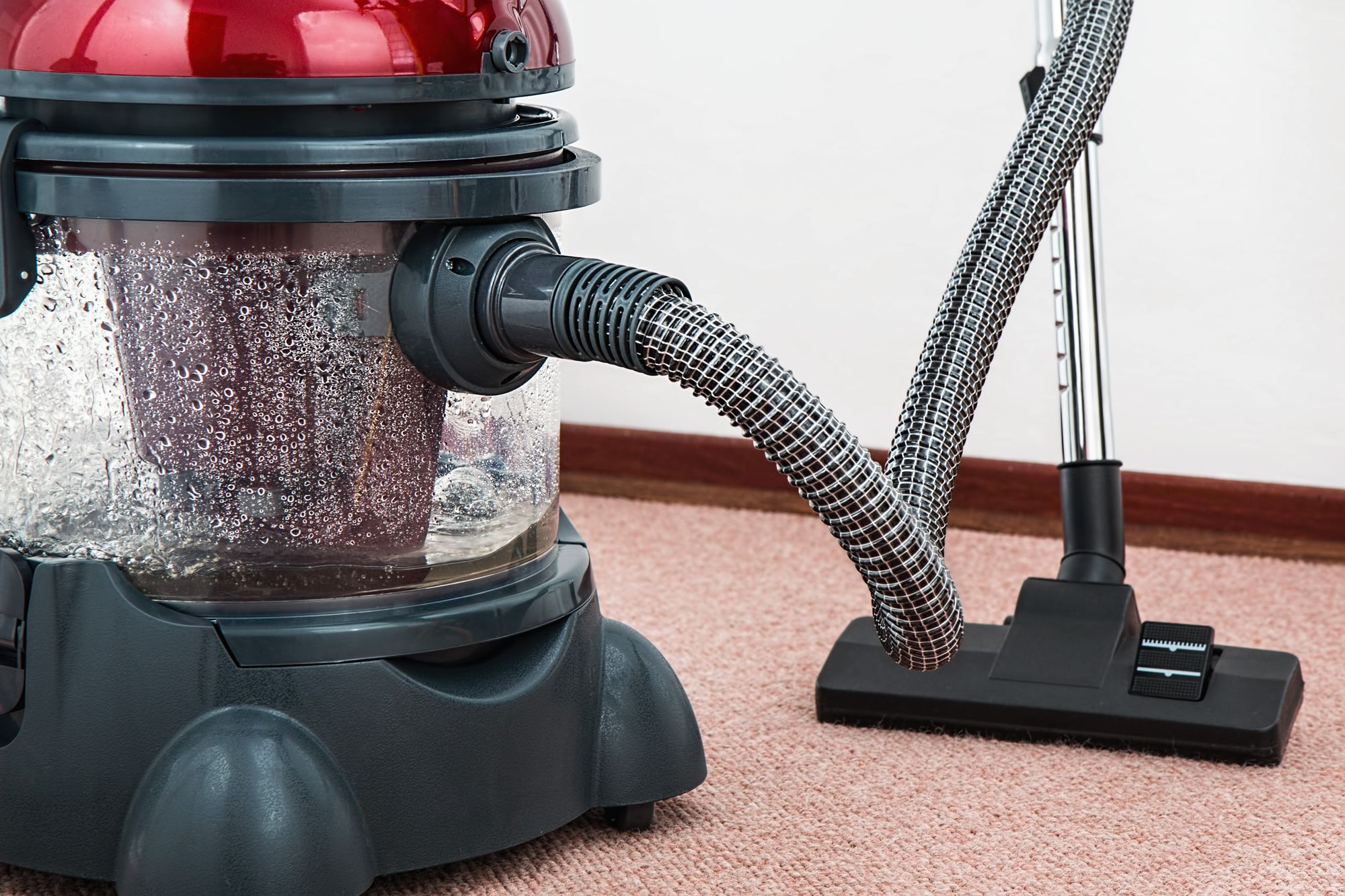 Carpet cleaning equipment ready beside a floor